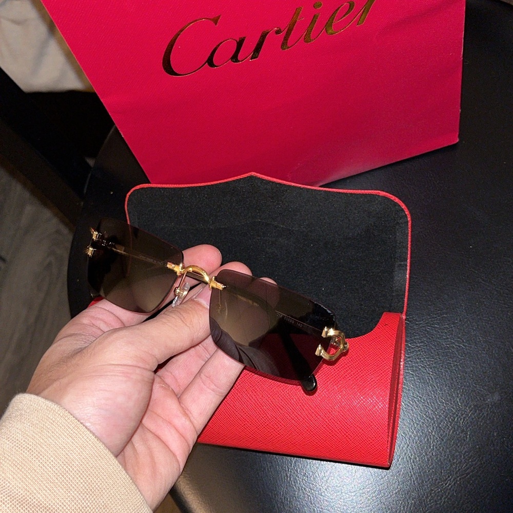 Cartier Women's Sunglasses with Black and Gold Design